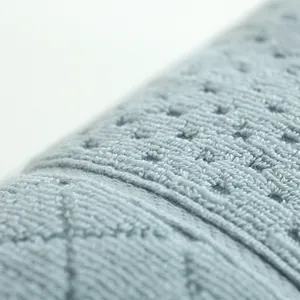 Close-up of light blue pure cotton towel featuring diamond quilted texture and breathable mesh