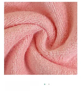 Close-up of pink thick cotton towel showing dense fiber texture and soft absorbent loops