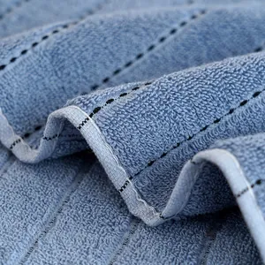 Thick light blue cotton towel featuring black dotted stripes and soft terry texture