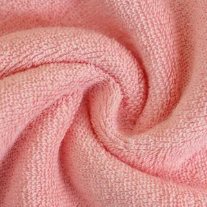 Soft pink cotton face towel with thick absorbent terry texture and spiral fold design