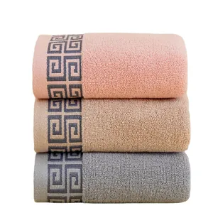 Three-pack cotton towel set in pink, brown and grey with Greek key pattern