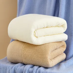 Close-up of thick absorbent cotton towels showing plush texture and vertical weave