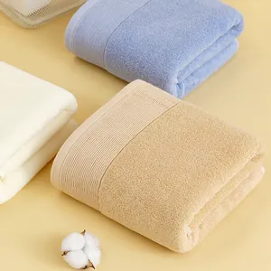 Three-piece absorbent cotton towel set in cream, blue and khaki with ribbed edge details