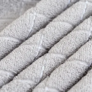 Macro shot of thick grey cotton towel with white geometric diamond stitching detail