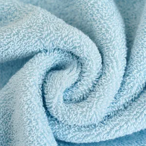 Thick light blue cotton towel with absorbent loop texture and soft fabric finish