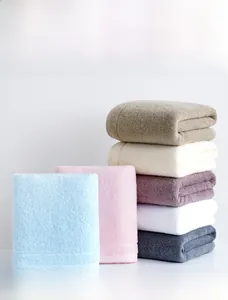Close-up of fluffy cotton towels in assorted colors showing absorbent loop texture