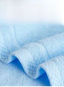 Macro shot of light blue combed cotton towel texture showing soft long fibers