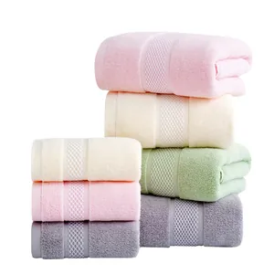 Absorbent cotton towel set featuring soft colors and decorative honeycomb weave bands