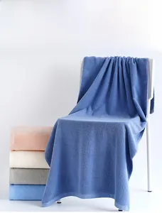 Close-up of premium cotton bath towels in various colors showing soft terry texture