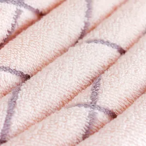 Thick cotton face towel with pink and purple geometric diamond pattern and soft texture