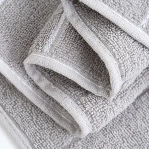 Thick grey cotton face towel with soft absorbent terry texture and fine stitching