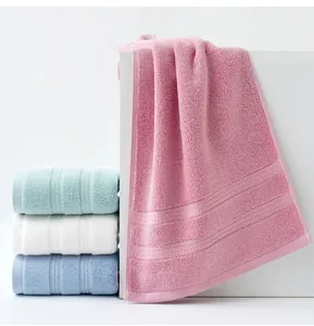 Detail of soft cotton towels with thick loops and parallel texture lines in pastel colors