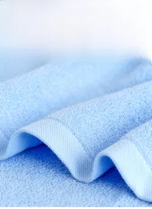 Detail of light blue combed cotton towel showing absorbent terry loops and reinforced edges
