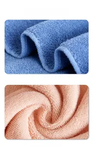 Close-up of blue and pink cotton bath towels showing soft terry loops and durable hemmed edges