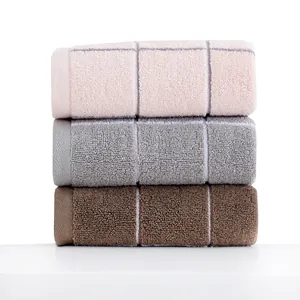 Thick cotton face towels with absorbent loop texture and minimalist cross pattern design