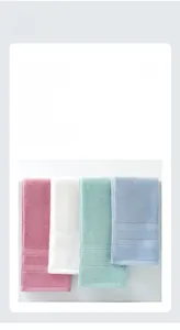 Detail of four-color thick cotton towels showing soft looped texture and ribbed borders