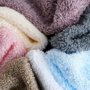 Thick cotton towel set in various soft colors with absorbent fluffy looped texture