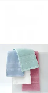 Detail of four colored cotton towels showing soft loop texture and quick-dry feature