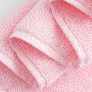 Thick soft pink cotton towel with high-absorbent loop texture and stitched edges