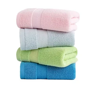 Set of four soft thick cotton towels in pink blue green and blue colors with dobby border