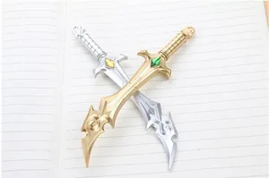 Detail of fantasy style miniature swords with gem-encrusted hilts on a notebook