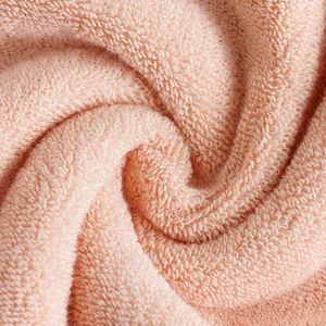 Thick coral pink pure cotton bath towel with absorbent terry cloth texture and soft feel