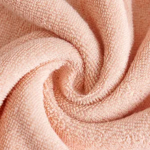 Thick oversized cotton bath towel in coral pink with dense luxury looped texture