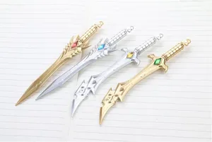 Detailed close-up of fantasy sword-shaped pens with colorful gems on a notebook