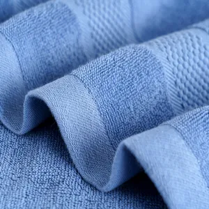 Thick blue cotton bath towel with textured jacquard pattern and premium absorbent loops