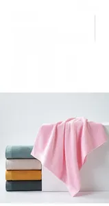 Detailed texture of cotton towels showing the 3D geometric pattern and soft fabric