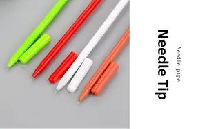 Close-up of needle pipe pen tips in green, red, white, and orange for precise writing