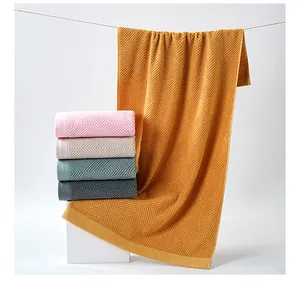 Detail view of cotton towels showing textured diamond weave and vibrant color options