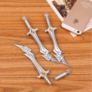 Silver sword-shaped creative gel pens with orange gems on a wooden desktop background