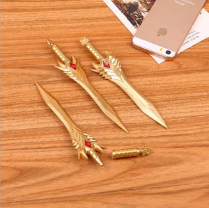 Golden fantasy sword-shaped neutral pens with red gems on rustic wooden background