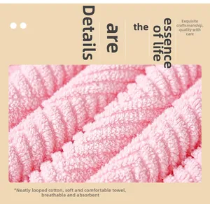 Close-up of pink cotton towel featuring absorbent spiral loops and soft texture details