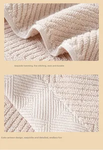 Detail showing high-quality beige cotton towel with durable hem and diamond weave pattern