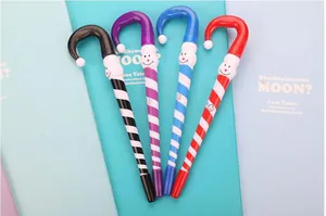 Set of four striped Christmas magic wand ballpoint pens with cartoon smiley face toppers