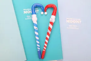 Close-up of candy cane shaped Christmas ballpoint pens in red and blue spiral patterns