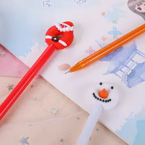 Detailed close-up of cartoon Christmas pens featuring Santa and Snowman silicone toppers