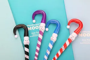 Detail of creative Christmas candy cane ballpoint pens with striped patterns and cute faces