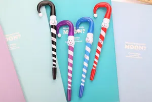 Close-up of colorful candy cane shaped Christmas ballpoint pens with cartoon character tops