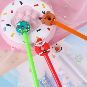 Close-up of four Christmas cartoon pens with silicone Santa, snowman and deer toppers