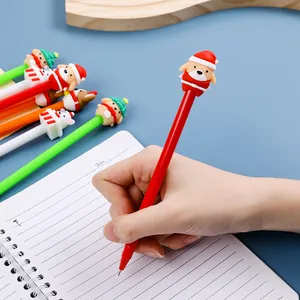 Lot de stylos gel de Noël avec figurines en silicone écrivant sur un carnet