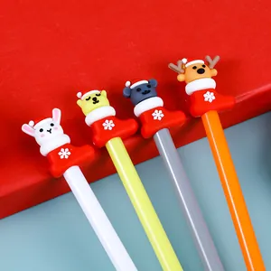 Close-up of four Christmas gel pens featuring silicone reindeer and animal charms in socks