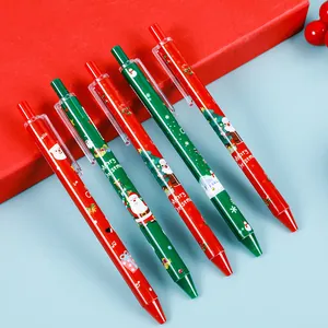 Détail de stylos rétractables de Noël avec motifs de Père Noël et sapin en rouge et vert