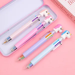Close-up of four unicorn multi-color ballpoint pens with a matching metal stationery box