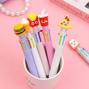Detail of 10-in-1 multi-color ballpoint pens with cartoon food silicone toppers in a pink cup