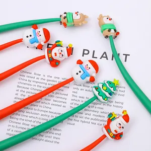 Close-up of Christmas pens with silicone Santa, Reindeer and Snowman toppers on red and green barrels