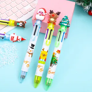 Detail of Christmas multi-color ballpoint pens with cartoon silicone toppers and festive prints