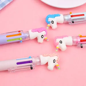 Close-up of cute unicorn 6-color ballpoint pens with soft 3D toppers on pink background